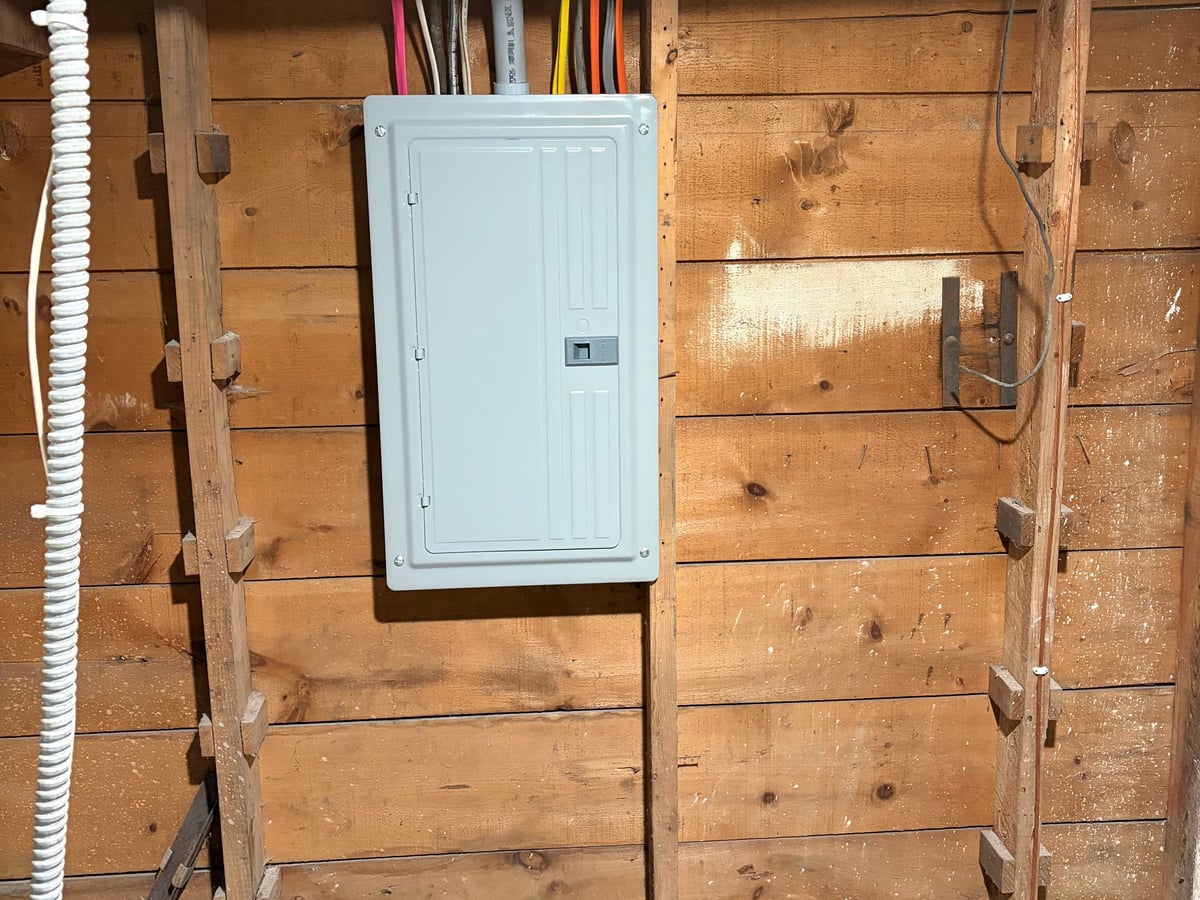 New electrical panel installed on exposed wall studs during a home panel upgrade